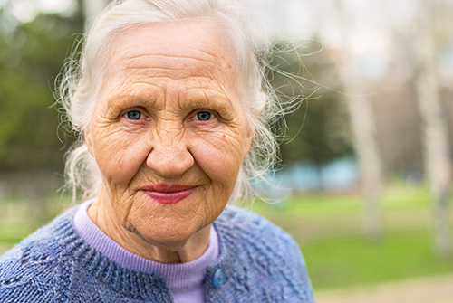 Close up of elderly woman wearing blue sweater outside